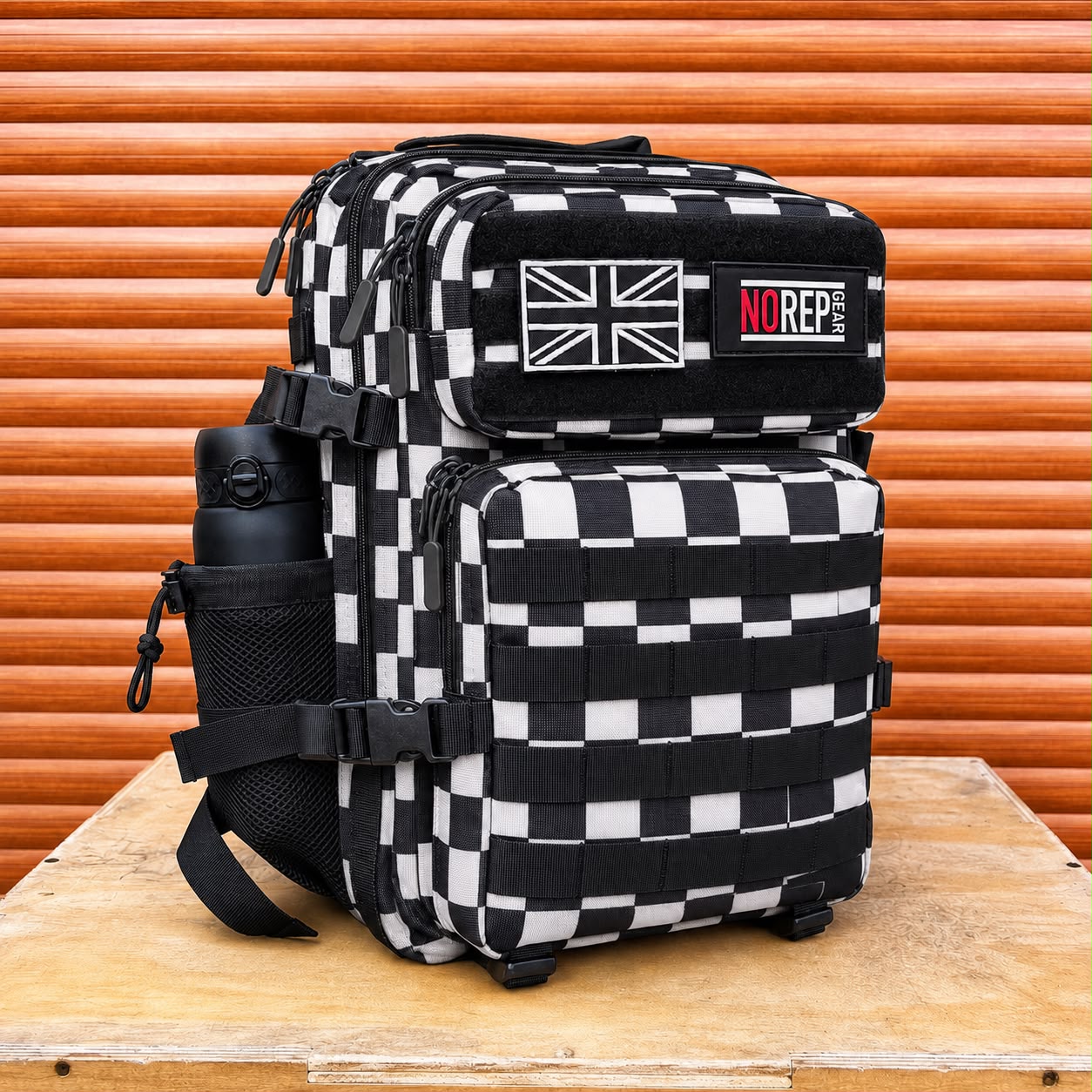 A black and white checkered tactical backpack with a side water bottle