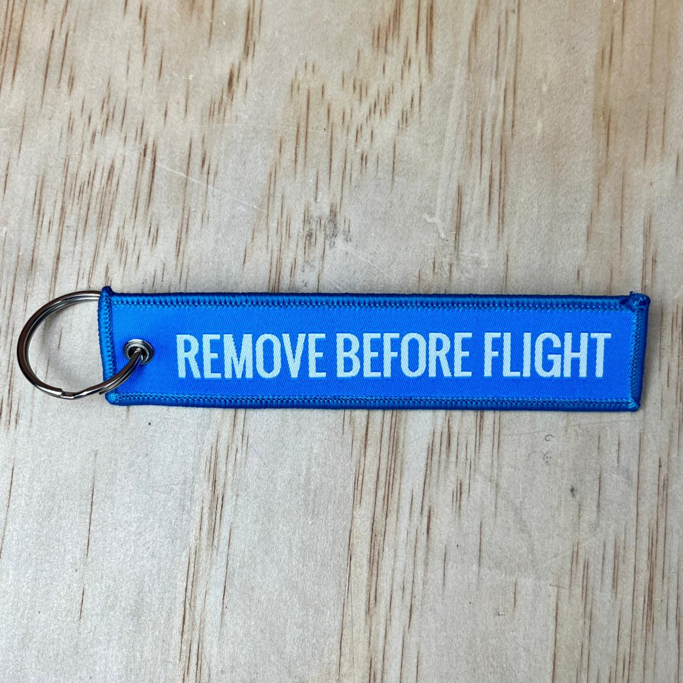 Remove before flight keyring, blue